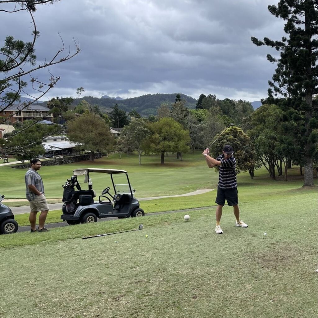 man chipping the golf ball