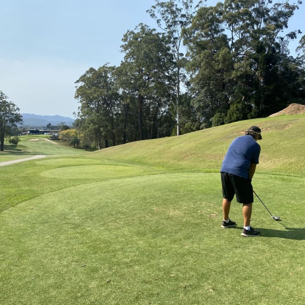 man swinging golf club